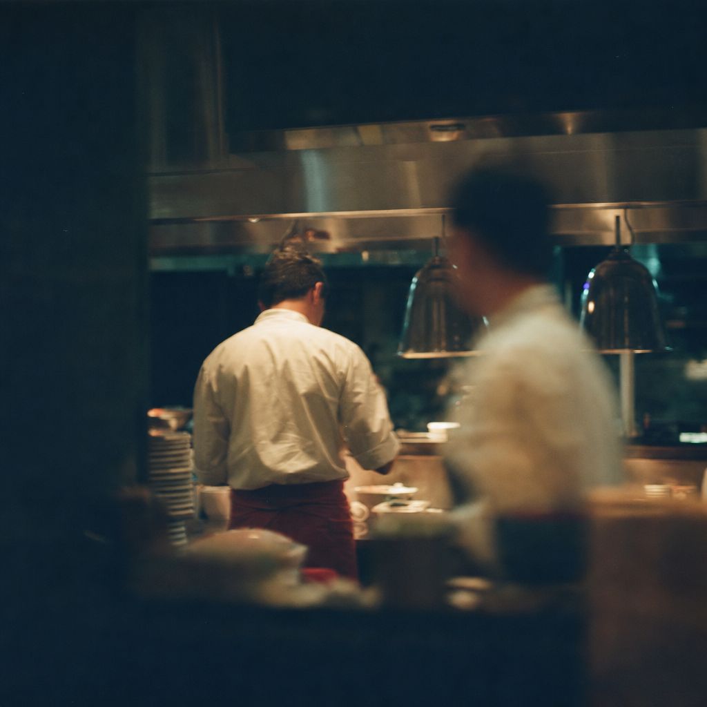 A cook on the line in a working kitchen
